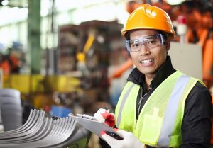 Portrait of young engineer taking notes for National Safety Month.