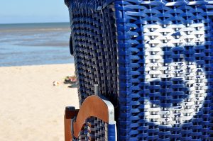Basket on a beach with a nail sticking out showing the need for liability insurance.
