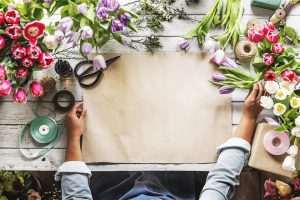 Florist designing a spread of flowers for a wedding. 