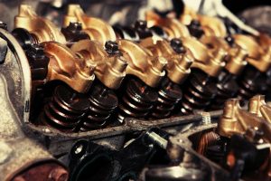 Gold Colored Cylinders in a Car Engine showing the need for Garage Liability Insurance.