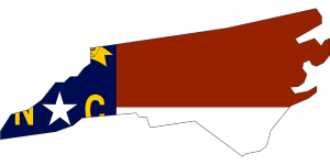 North Carolina Flag within the outline of the state border. 