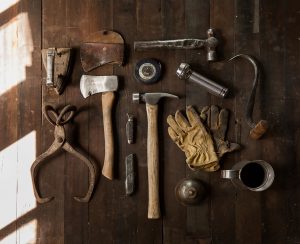 Multiple Tools used for Construction sitting organized on a brown wooden table. 